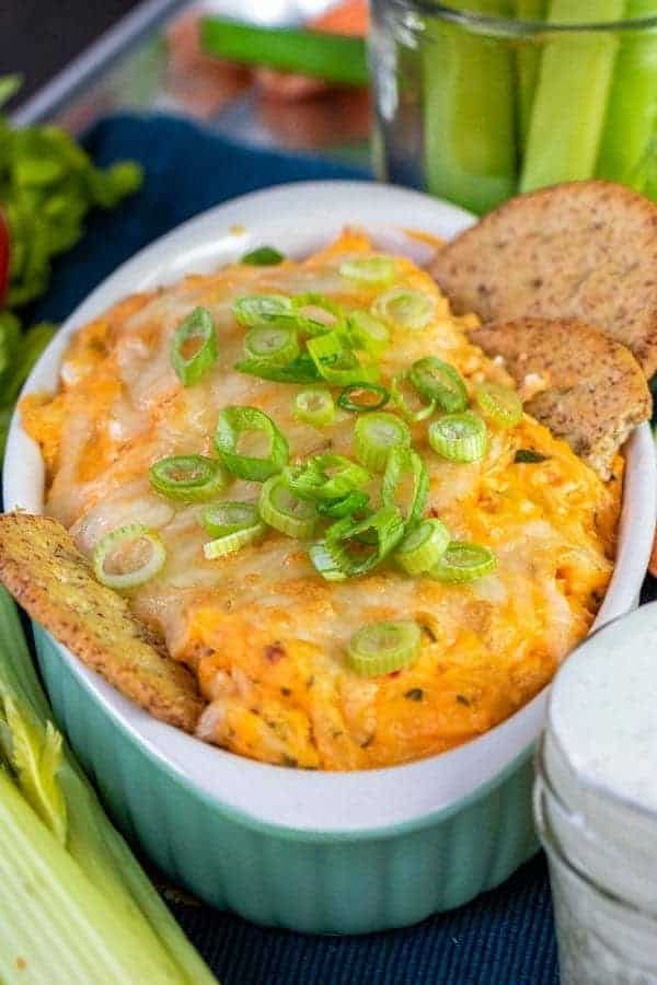 closeup of buffalo chicken dip with crackers and celery