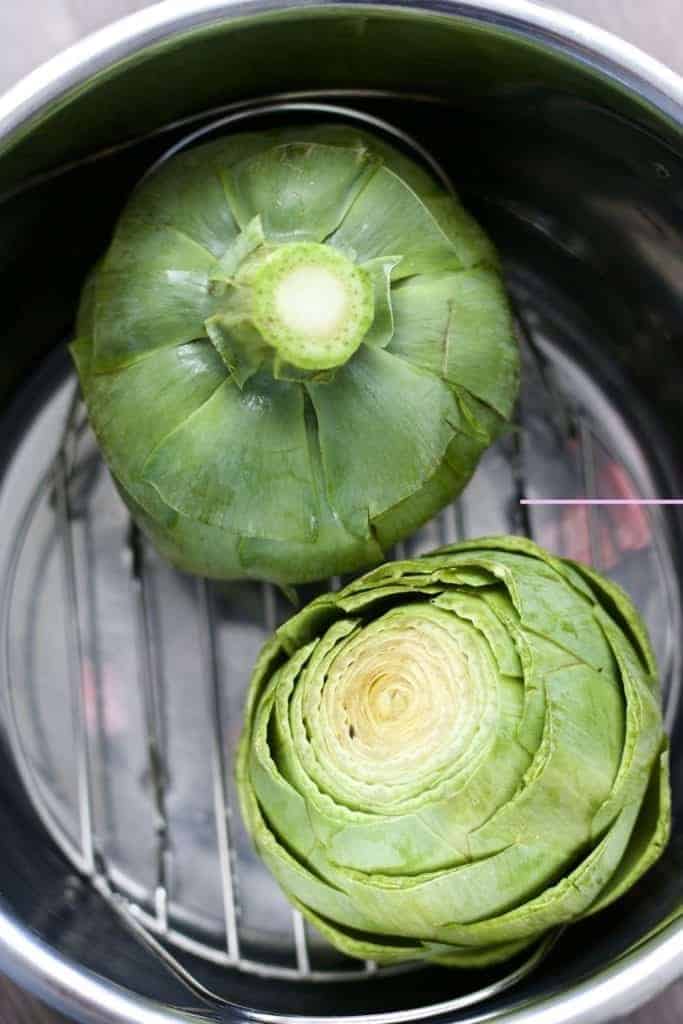 Trimmed artichokes, ready to be pressure cooked in the Instant Pot on a trivet