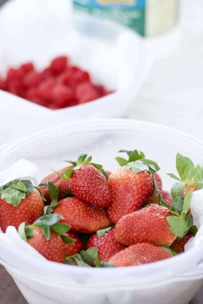 Strawberries and raspberries in a paper towel lined container help prevent moldy berries