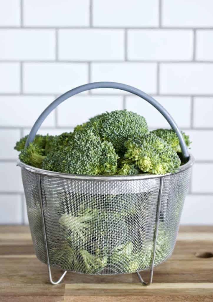 Broccoli florets in an instant pot steamer basket