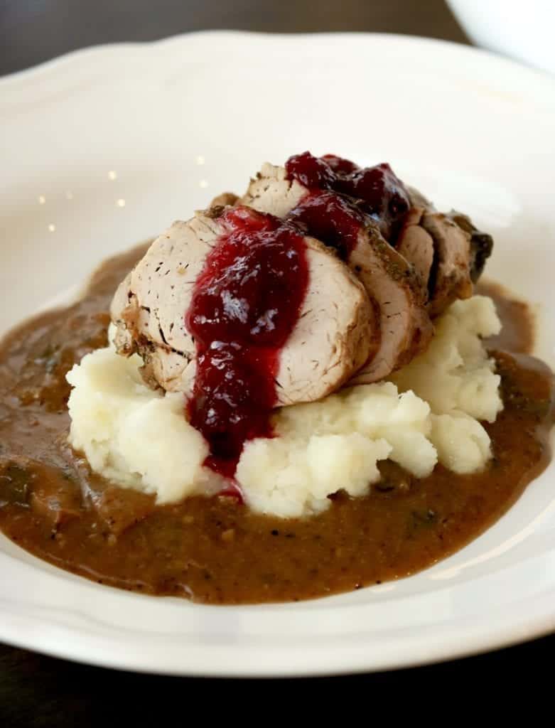 Instant pot cranberry sauce on top of Instant Pot pork tenderloin and Instant Pot mashed potatoes and gravy