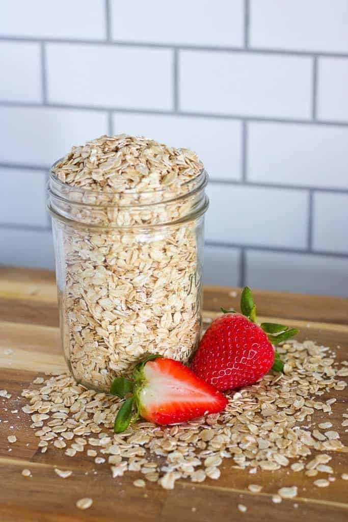 Jar of uncooked oatmeal with strawberries