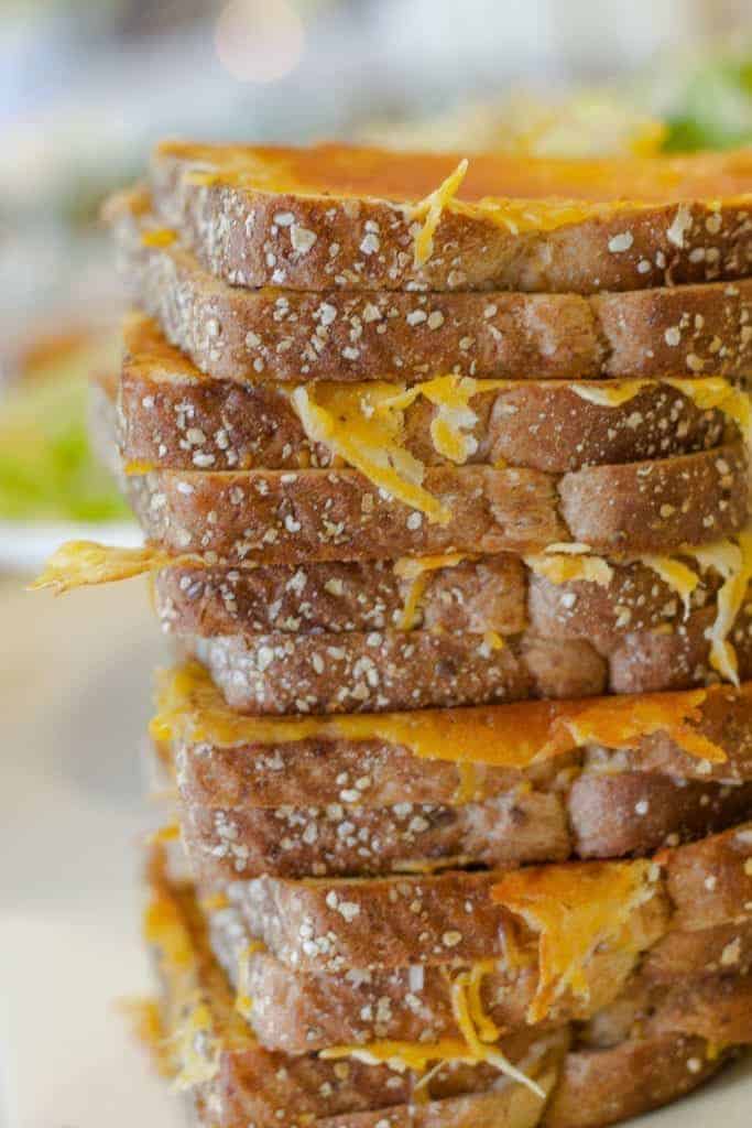 A stack of grilled cheese sandwiches with a crispy cheese crust