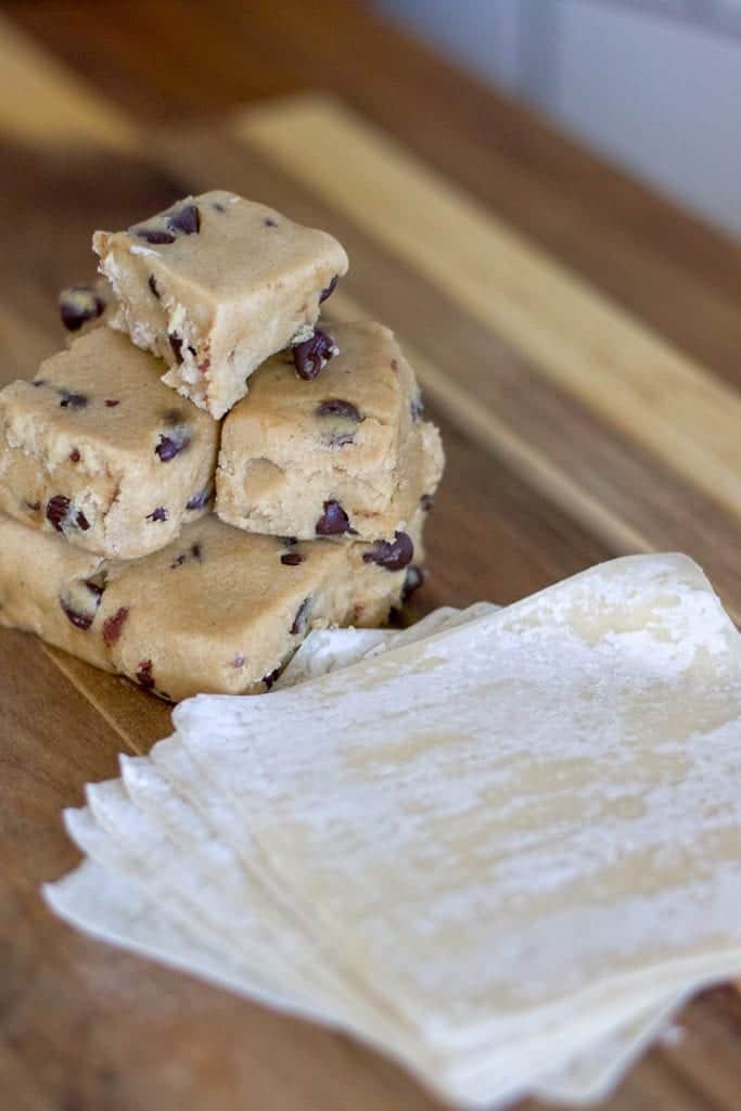 Cookie Dough and Wonton wrappers on a wooden cutting board