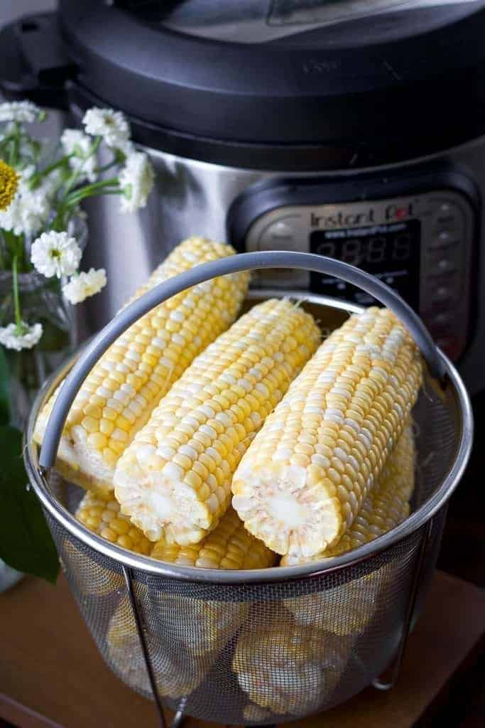 corn on the cob in a steamer basket