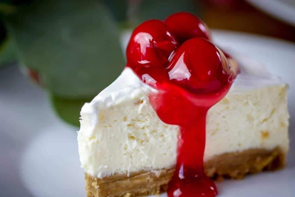 a piece of cheesecake with cherry topping