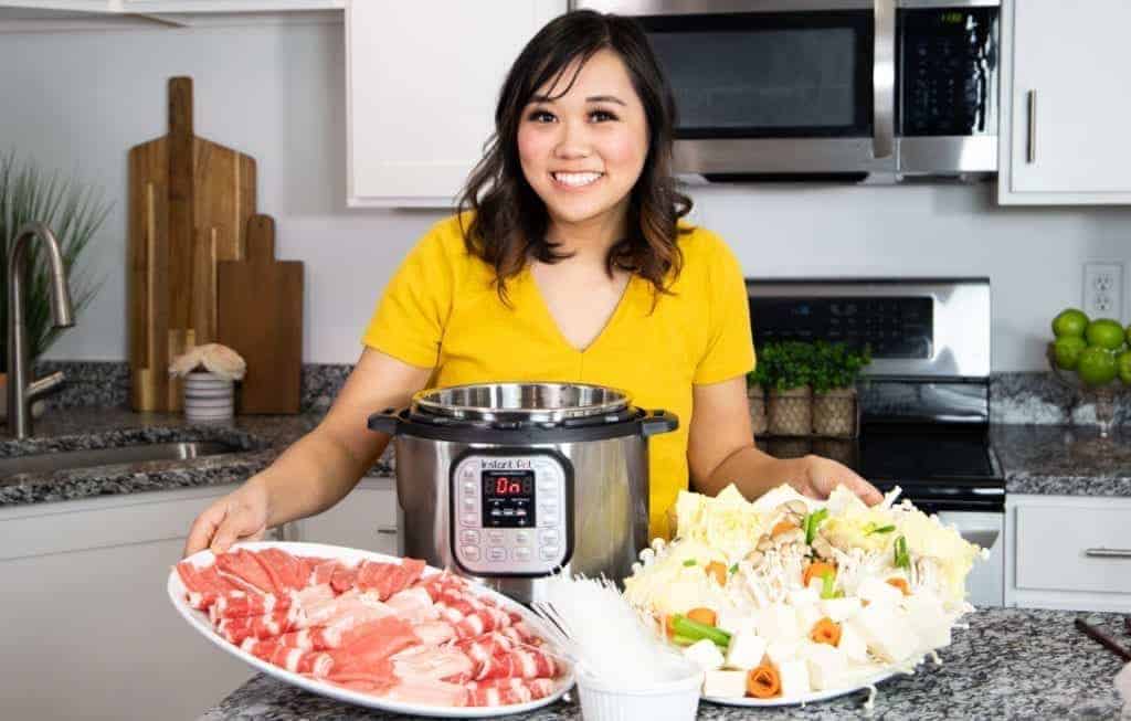 Lisa Childs holding trays of her homemade shabu shabu recipe