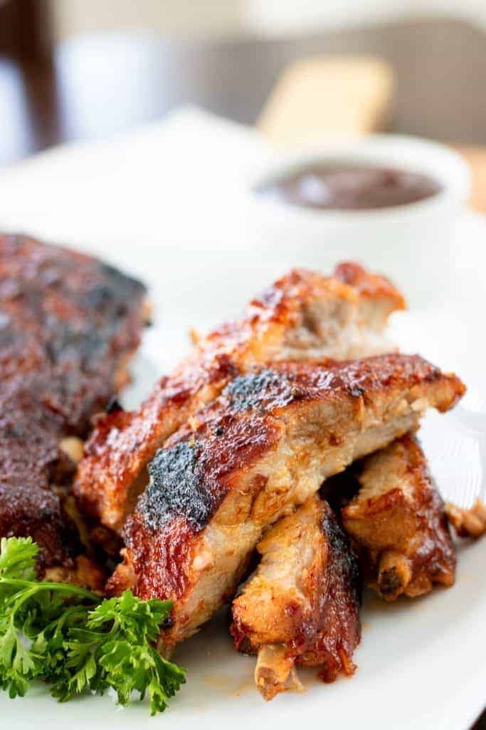 pieces of ribs with bbq sauce in the background