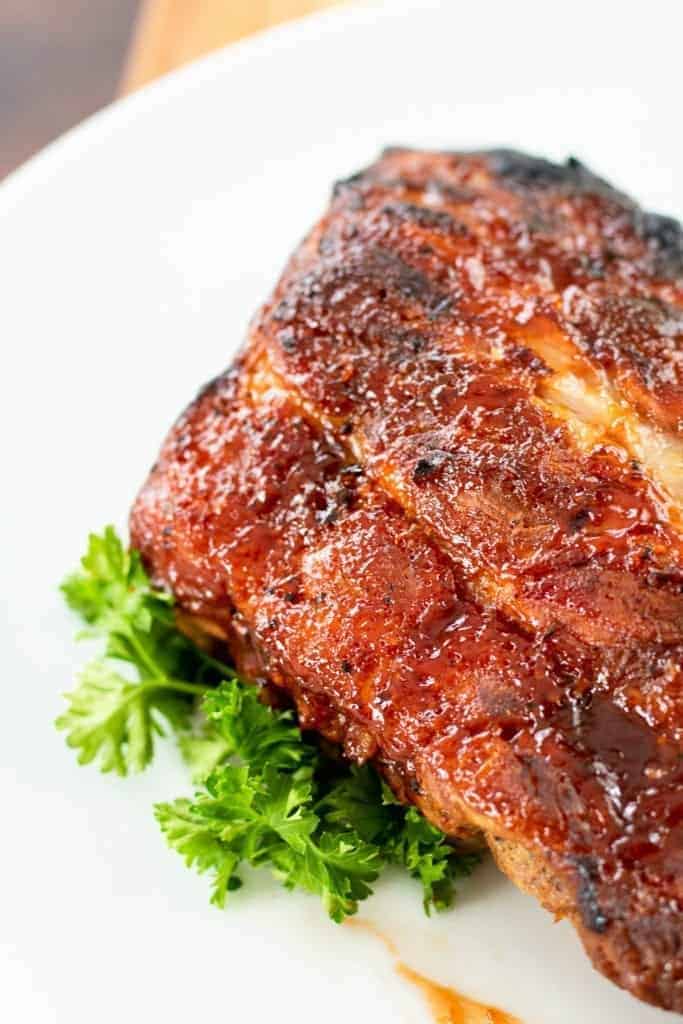 a large slab of ribs with a sprig of parsley