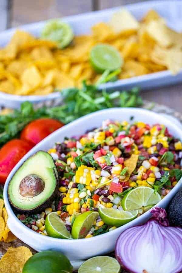 black bean and corn salad with chips in the background