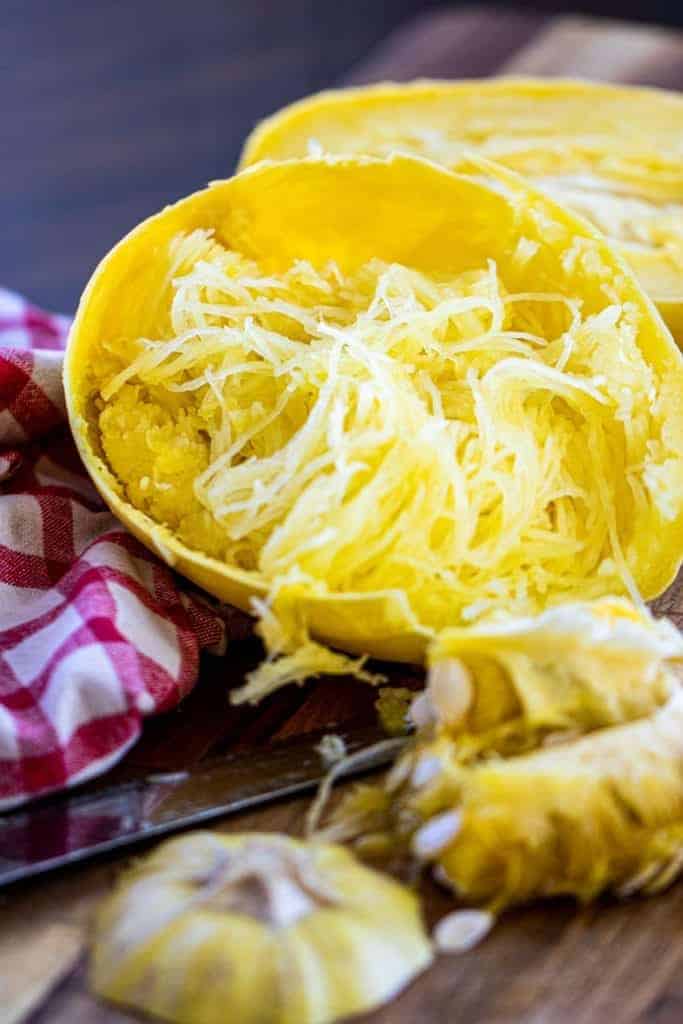 cooked spaghetti squash on a red napkin in the shell