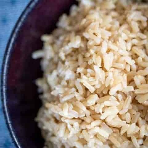 brown rice in a purple bowl