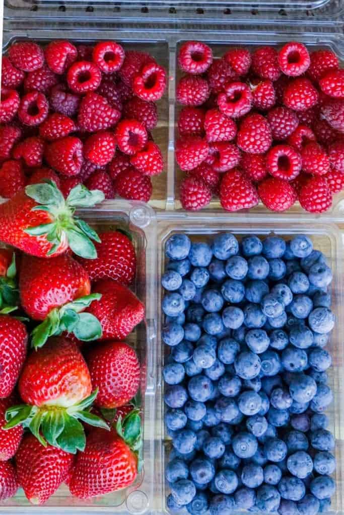 a carton of blueberries, strawberries, and raspberries