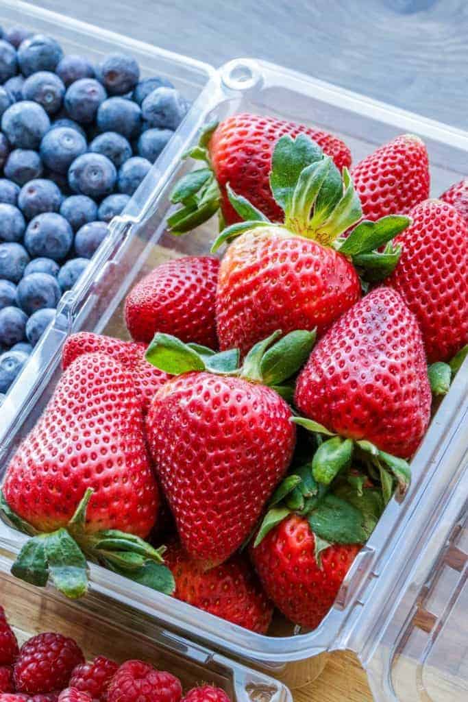 a closeup of a carton of strawberries