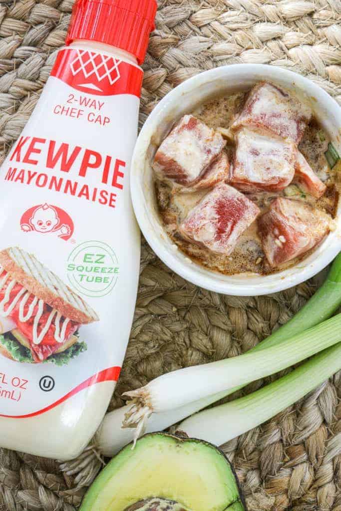 kewpie mayo next to a bowl of creamy spicy tuna poke