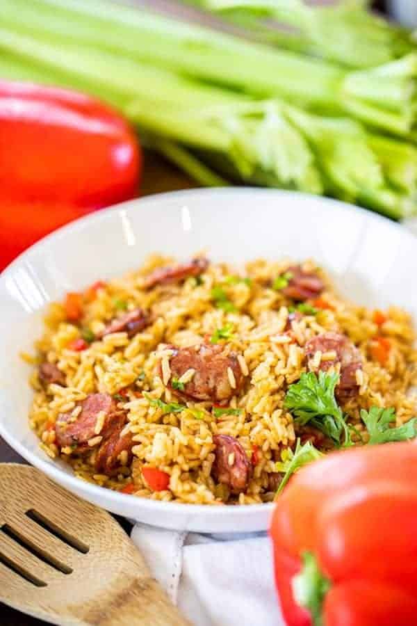 a bowl of Instant Pot cajun rice with peppers and celery in the background