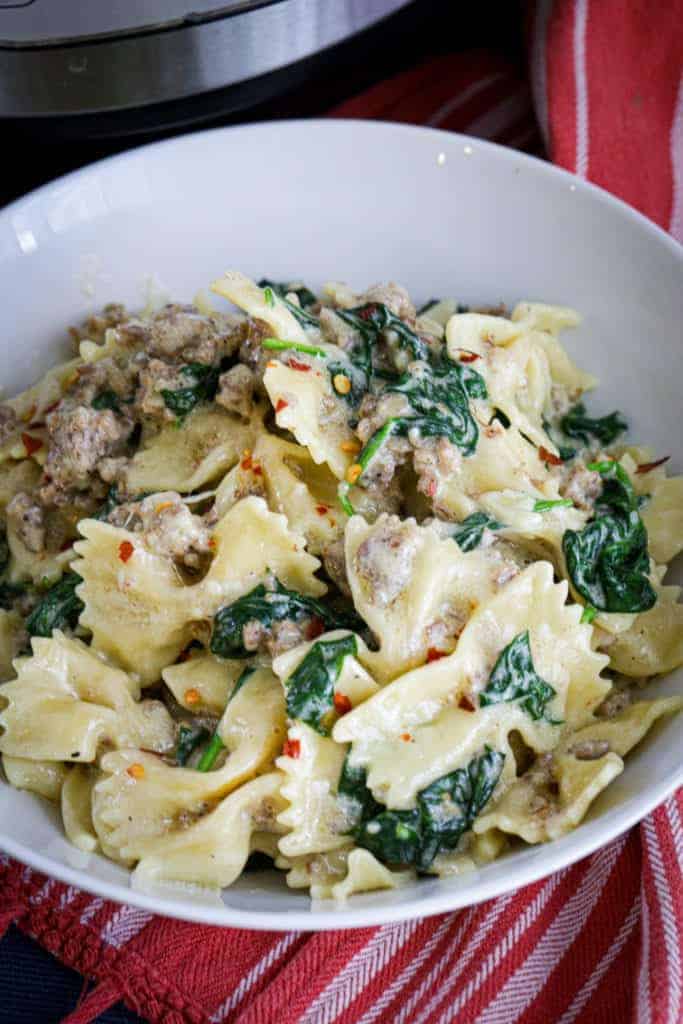 closeup of Instant Pot bowtie pasta with sausage and kale