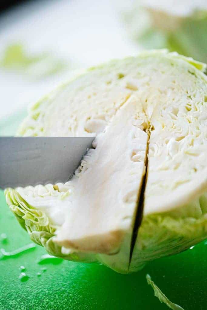 knife cutting out core of cabbage