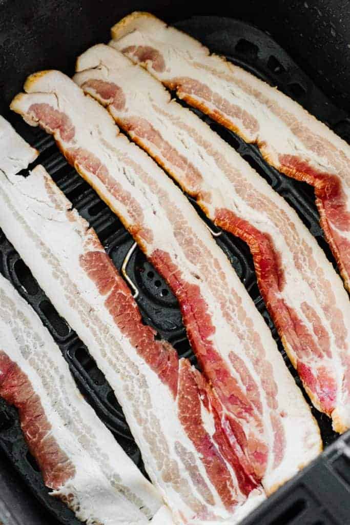 Five raw bacon strips in air fryer