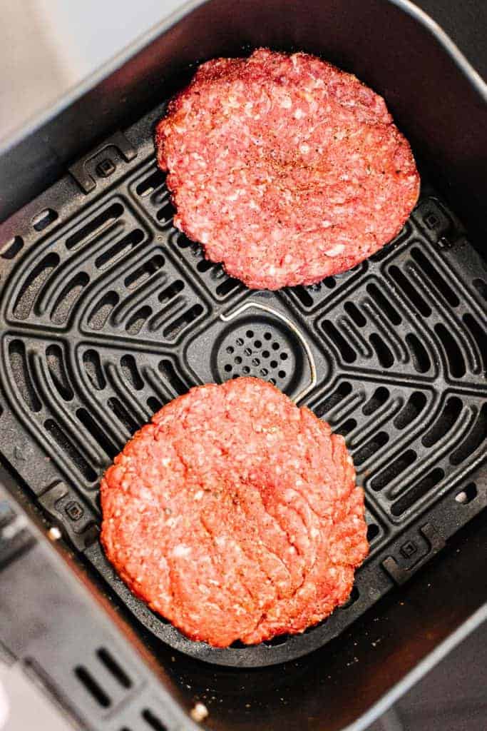 Raw hamburger patties in air fryer