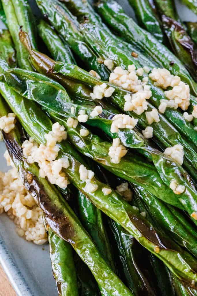 Close up of green beans topped with garlic