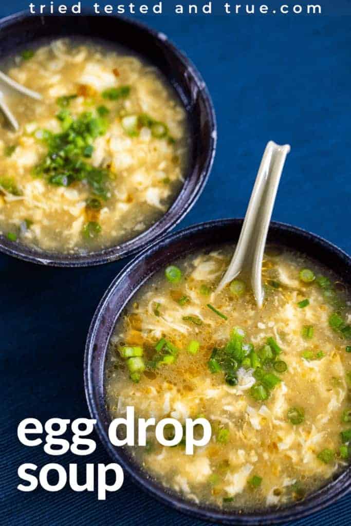 two bowls of egg drop soup on a blue background