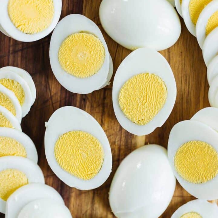 Several instant pot eggs sliced in half to show cooked yellow yoke and egg whites