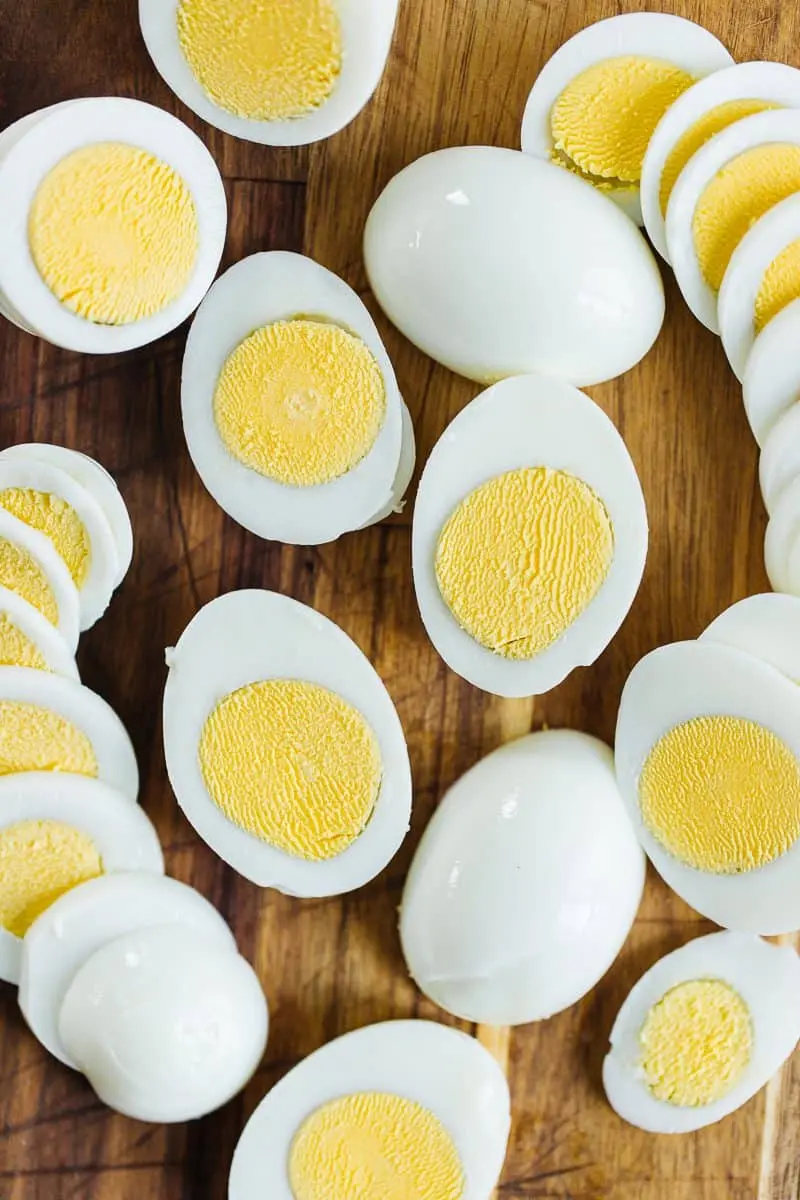 Several instant pot eggs sliced in half to show cooked yellow yoke and egg whites