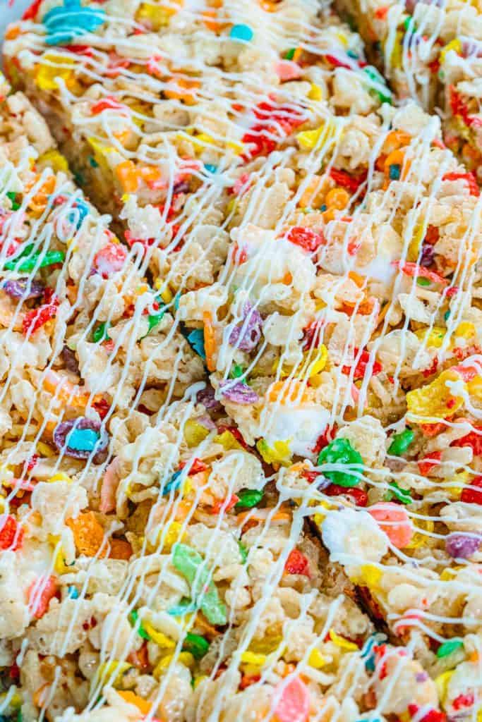close up of fruity pebble rice krispies drizzled with white icing