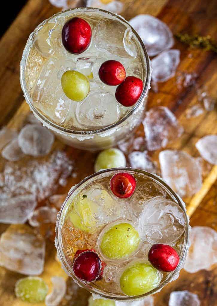 an overhead view of two glasses of non alcoholic white grape mocktail