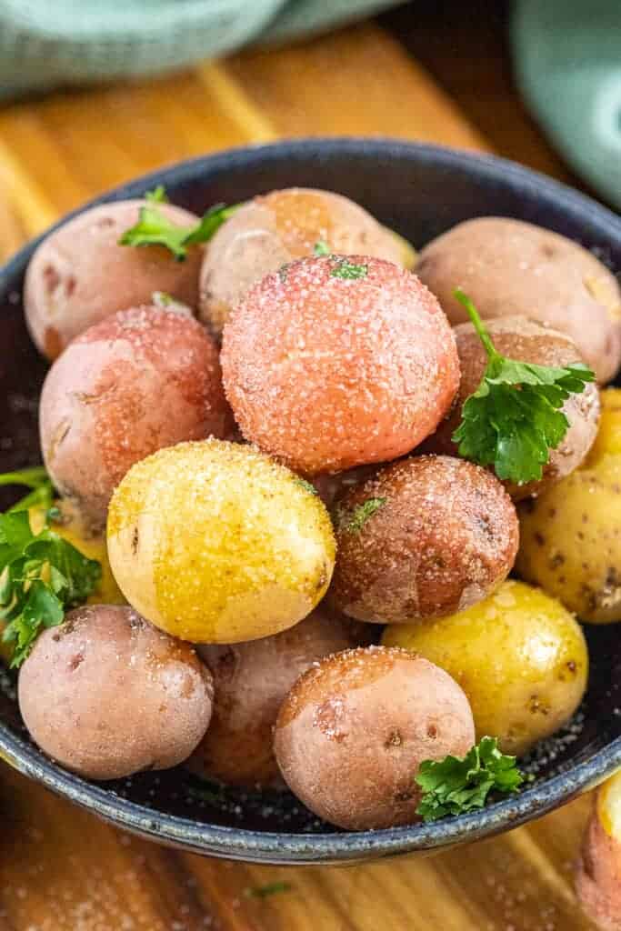 a bowl of salt potatoes in a dark blue bowl